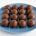 12 Mini Chocolate and Oat Protein Balls on Blue Plate